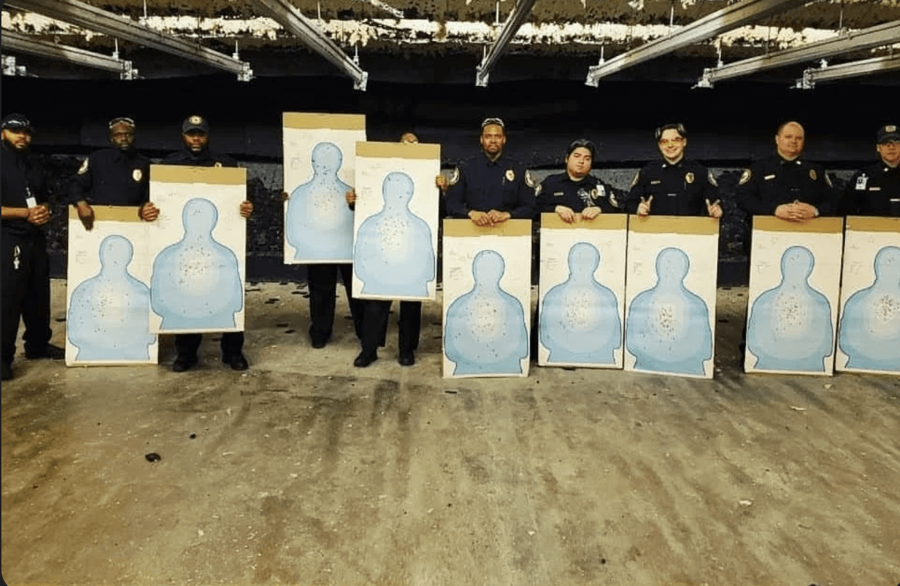 Armed special police officers displaying completed range qualification targets