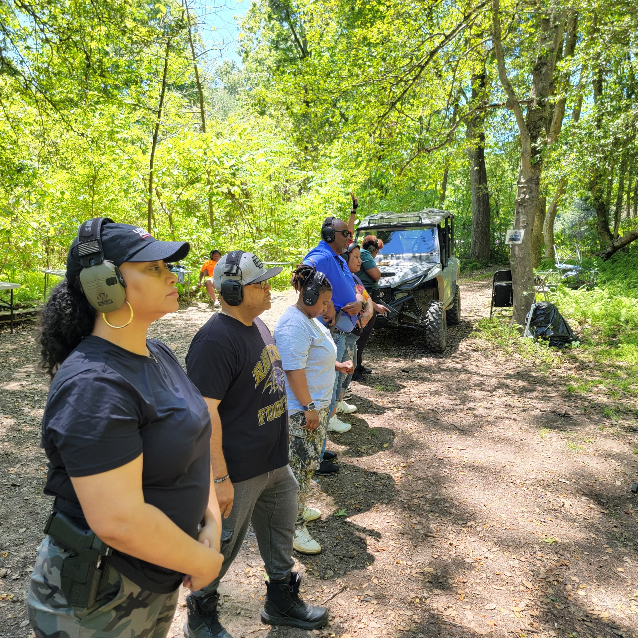 Students wearing hearing protection during a safety briefing at the outdoor range