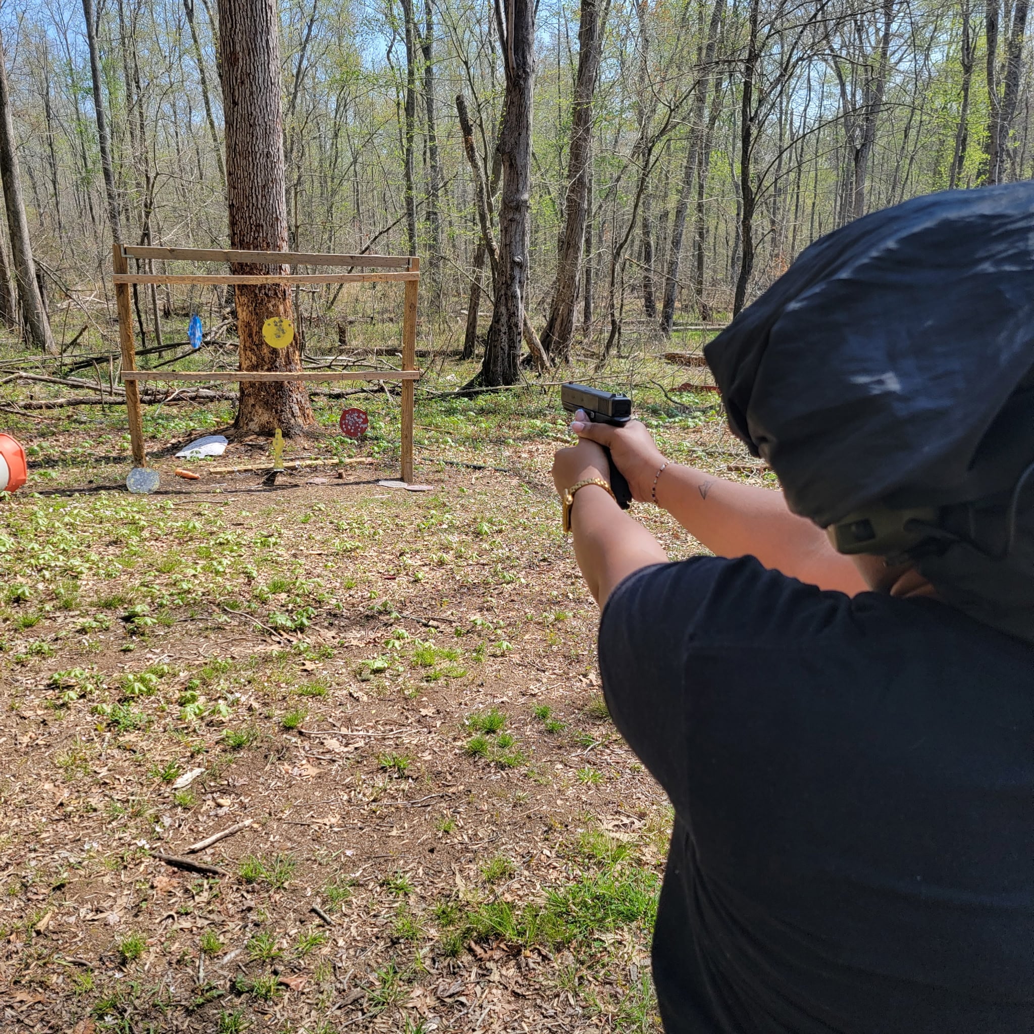 Student practicing marksmanship with steel targets at the outdoor range